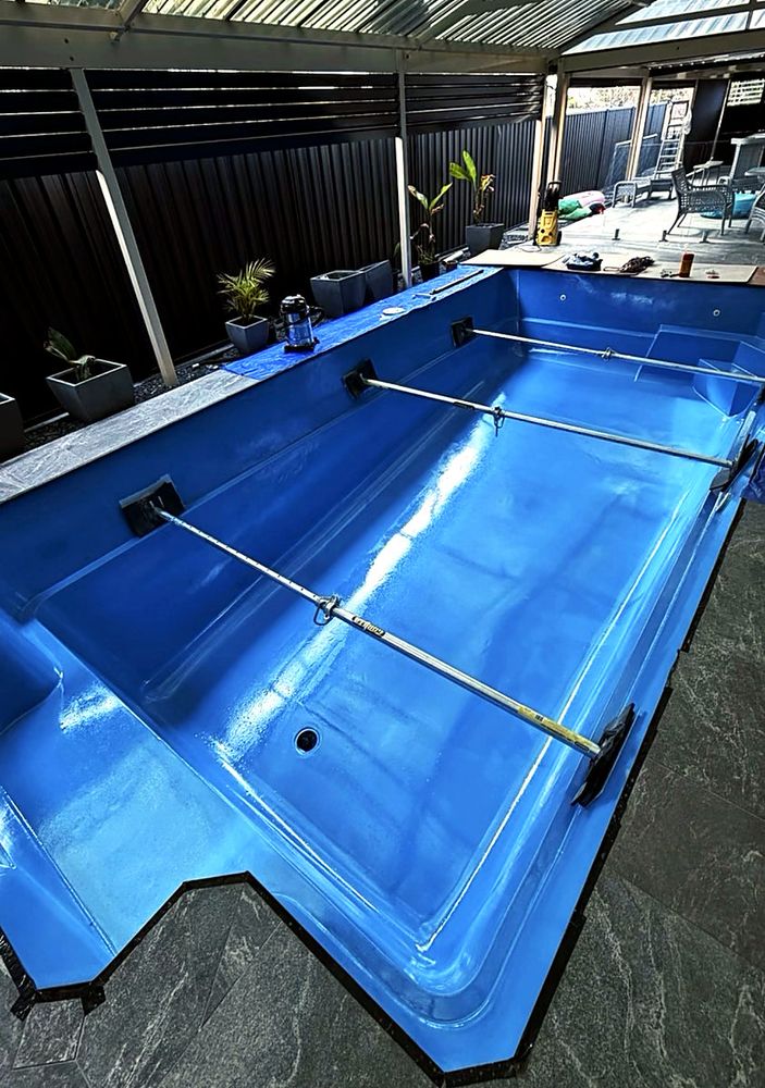 Fibreglass pool freshly coated in blue epoxy