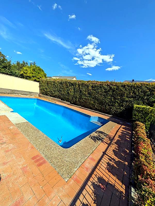 Freshly finished blue pool under clear sky
