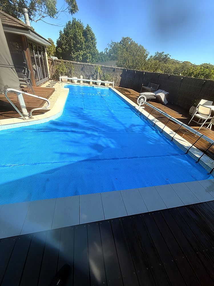Pool with a solar cover and roller