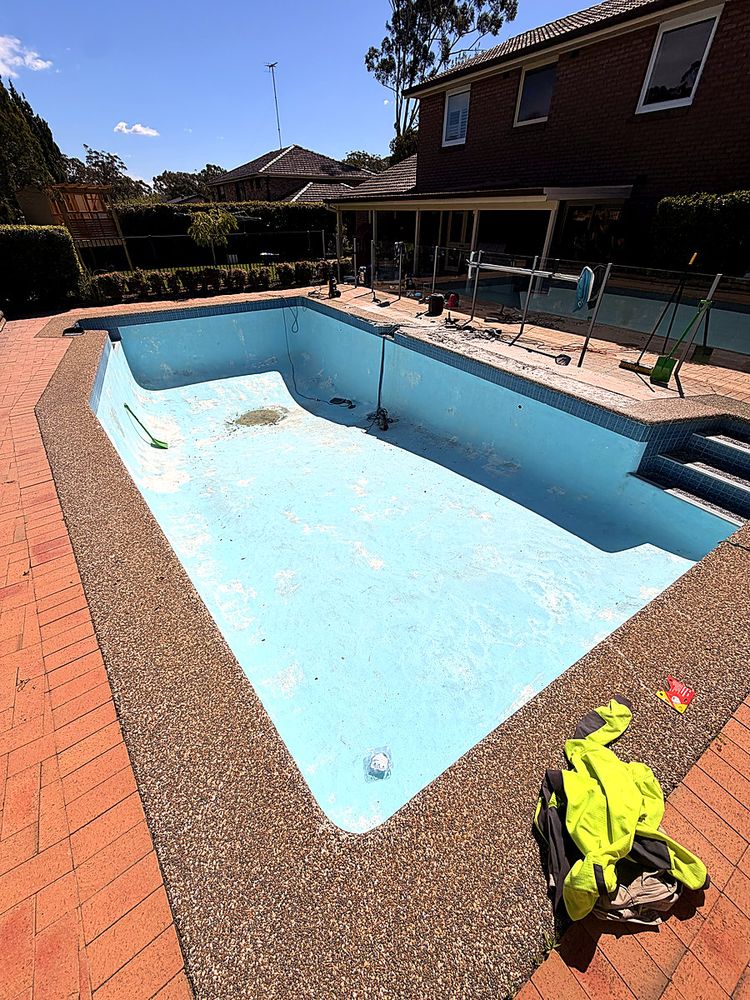 Worn pool interior and coping before work