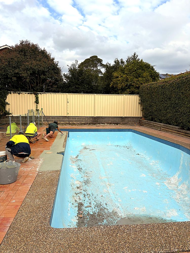 The Lukewarm crew working on pool coping